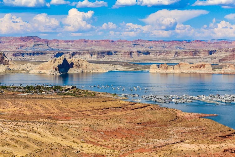Desert cliffs overlooking blue lake marina