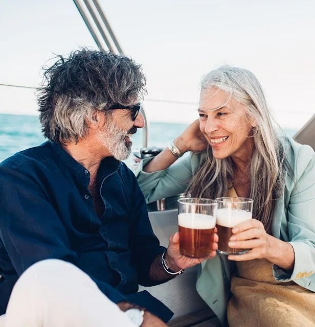 couple enjoying drinks while on a boat on a lake