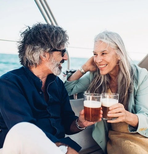 couple enjoying drinks while on a boat on a lake